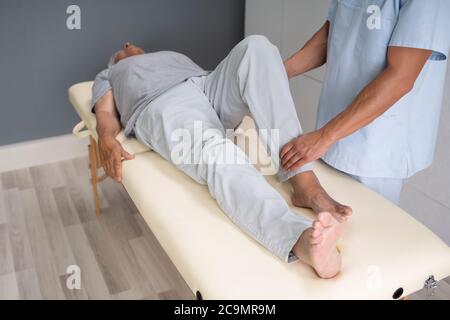 Doctor Doing Check And Physiotherapy Rehab After Injury Stock Photo