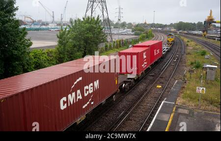 CMA CGM container on goods train leaving Southampton docks. Stock Photo