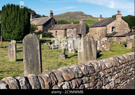 Pen-y-ghent peak seen from St Oswald's Parish Church in the Yorkshire Dales National Park village of Horton-in-Ribblesdale. Stock Photo