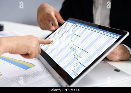 Convertible Laptop With Gantt Software Chart And Agenda Stock Photo