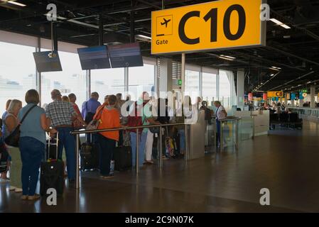 AMSTERDAM, NETHERLANDS - SEPTEMBER 17, 2017: Passengers are queuing for boarding a plane in the departure area on the Schiphol Airport Stock Photo