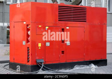 Mobile electric power generator for emergency situations, red color on outdoor. Stock Photo