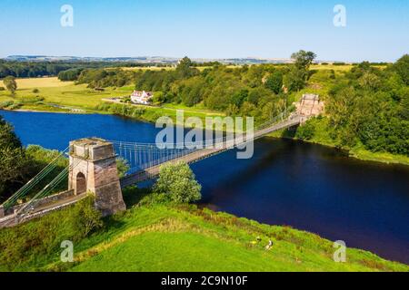 The Union Suspension Bridge which spans the river Tweed between Horncliffe, Northumberland, England and Fishwick, Scottish Borders, Scotland. Stock Photo