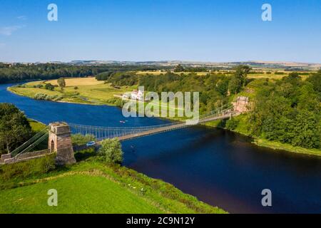 The Union Suspension Bridge which spans the river Tweed between Horncliffe, Northumberland, England and Fishwick, Scottish Borders, Scotland. Stock Photo