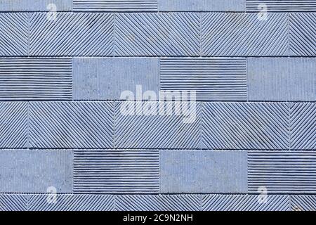 Texture of a wall from a stone tile, a striped pattern of a rectangular tile. Stock Photo