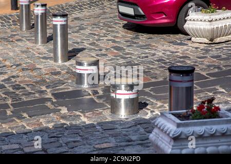 Retractable Electric Bollard Metallic, and hydraulic for the control of road traffic locked up underground. Stock Photo