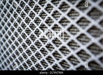 A close up shot of aluminum mesh with shallow depth of field. These mesh are used in homes for ventilation and keeping the insects out. Stock Photo