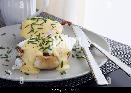 Eggs Benedict- toasted muffins, ham, poached eggs, delicious buttery hollandaise sauce Stock Photo
