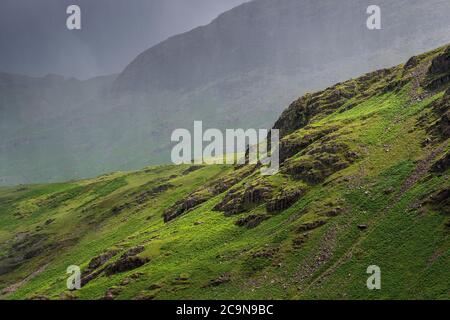 Stormy weather in the English Lake District with heavy thunder showers after warm weather giving a dramatic view over Little Langdale, from Wrynose Pa Stock Photo