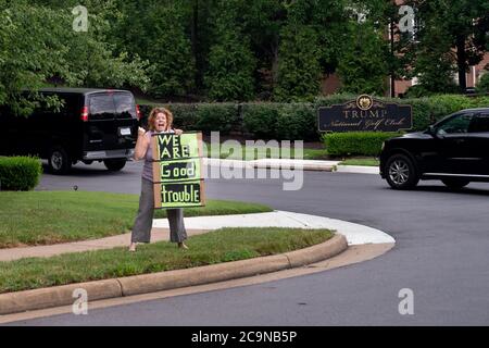 Sterling, United States. 01st Aug, 2020. Protesters hold signs outside