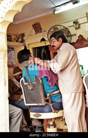 Indian people and their daily life living . Barber shop in Jaisalmer old tow in Rajasthan. Feb.2013 India