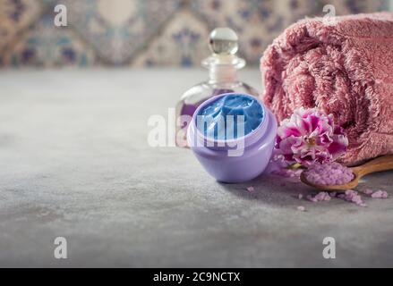 Spa. Natural cream, sea salt, flowers and a towel. Copy background space. Selective focus Stock Photo
