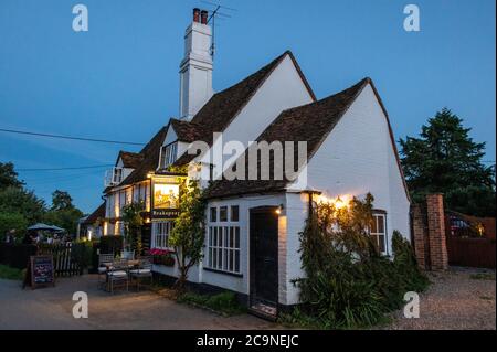 The late daylight summer evenings drawing to a close at the Bull and Butcher public house in the village of Turville in the Chiltern Hills in south Bu Stock Photo