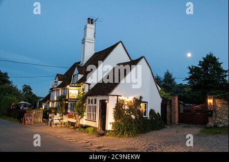 The late daylight summer evenings drawing to a close at the Bull and Butcher public house in the village of Turville in the Chiltern Hills in south Bu Stock Photo