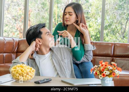 Happy Asian couple relax in living room. Stock Photo