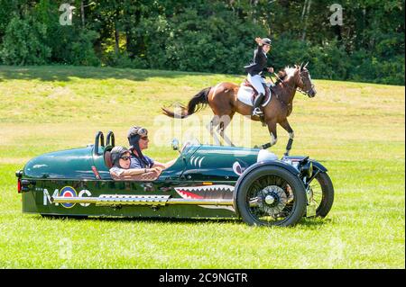 Morgan 3-Wheeler racing a horse at the Collings Foundation's Race of the Century event. Stock Photo
