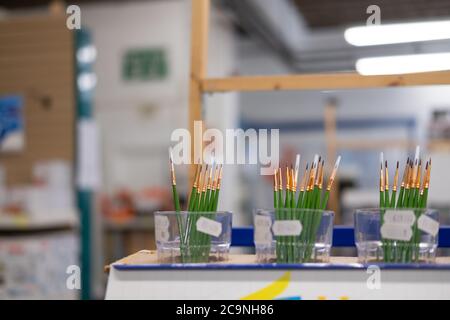 Shallow focus hobbyist paintbrushes seen within a general and hobby store. The fine brushes are clearly evident. Stock Photo