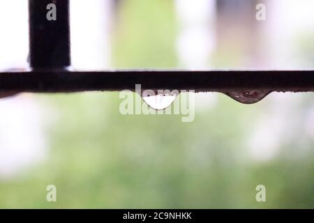 Water drop on window rod Stock Photo