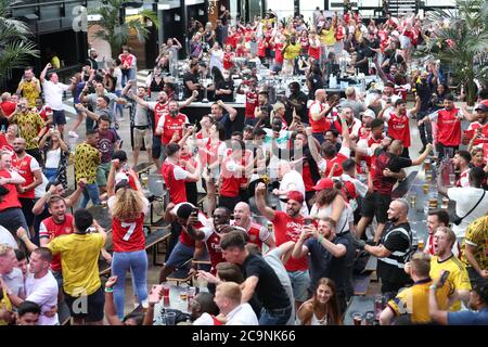 Arsenal fans celebrate at Box Park Wembley in London after Pierre-Emerick Aubameyang scores his side's first goal of the game from the penalty spot in the FA Cup final between Arsenal and Chelsea at Wembley Stadium. Stock Photo