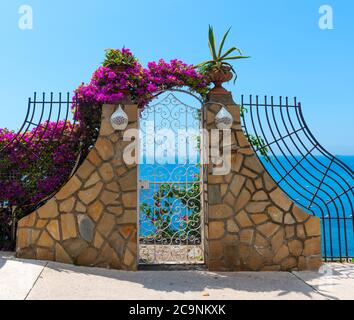 Small gates by the cliff on a clear day in Positano, Italy Stock Photo