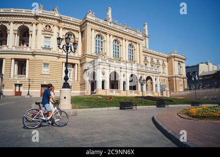 ODESSA, UKRAINE - AUGUST 06, 2015: cute young beautiful hipster couple with bikes travelling Europe Stock Photo