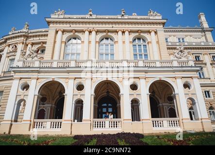 ODESSA, UKRAINE - AUGUST 06, 2015: cute young beautiful hipster couple travelling Europe, standing near the Opera House Stock Photo