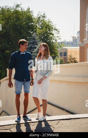 Happy stylish loving couple is talking at the street, outdoors summer time Stock Photo