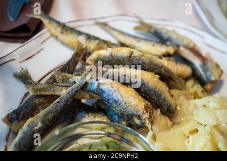 Grilled Sardines on a plate in a restaurant Stock Photo
