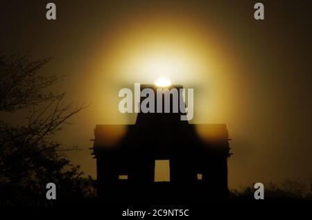 Sunrise above the temple of the seven dolls ('templo de las siete muñecas') during spring equinox in Dzibilchaltún Stock Photo