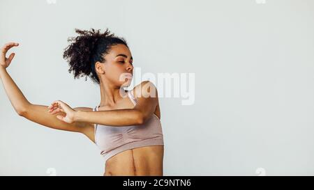 Young woman practicing dancing moves with hands in the studio Stock Photo