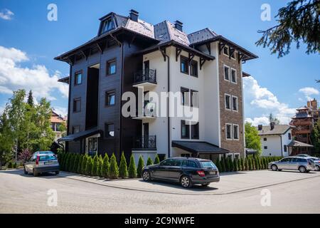 Zlatibor, Serbia - July 25. 2020 Big building house with parking on the mountain resort on a sunny summer day Stock Photo