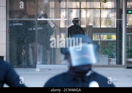 US Marshals behind the smashed doors of the US Courthouse. Rubber bullets were shot by LAPD. Stock Photo