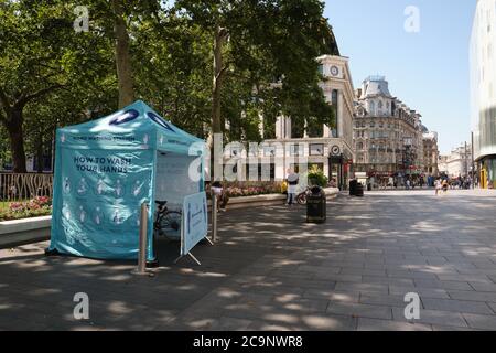 Hand Washing Station at Leicester Square in London, UK to provide free masks, gloves and hand sanitizer to the public amid COVID-19 pandemic. Stock Photo