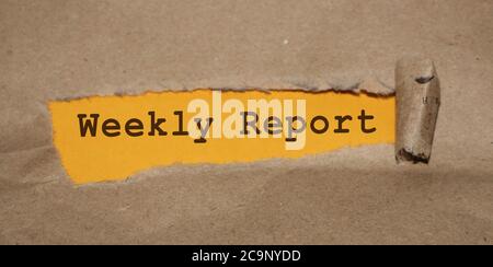 torn paper with words weekly report. Business concept Stock Photo