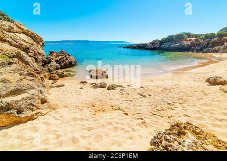 Golden sand and rocks in a small cove in Alghero. Sardinia, Italy Stock Photo