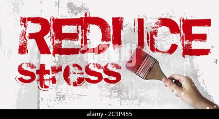 Reduce stress concept, red words on grunge wall. Mental health concept Stock Photo
