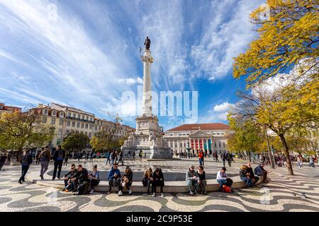 Lisbon, Portugal - March 21, 2018: People outdoors in the Rossio square town of Lisbon on a sunny day in the fall season Stock Photo