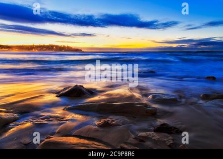 Dark sunrise over Pacific ocean at Bondi beach in Sydney, Australia. Stock Photo