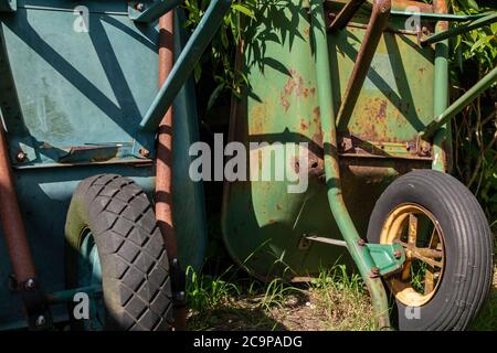Two old wheelbarrows in a garden Stock Photo