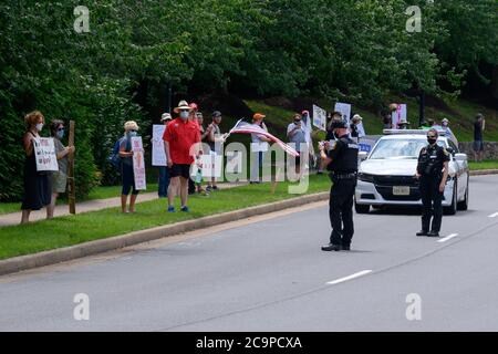 Sterling, United States. 01st Aug, 2020. Protesters hold signs outside