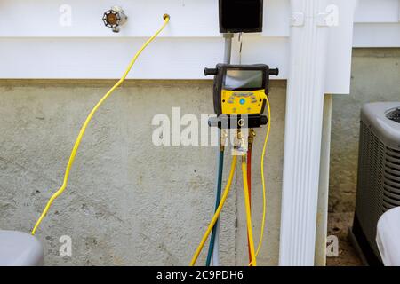 A preparing to install vacuum pump checking new air conditioner during the installation process Stock Photo