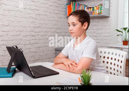 Kid using tablet learning at home. Home schooling, distance learning Stock Photo