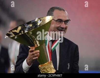 Turin, Italy. 1st Aug, 2020. Maurizio Sarri, head coach of FC Juventus, poses with the trophy at the end of the Serie A football match between FC Juventus and Roma in Turin, Italy, Aug 1, 2020. Credit: Alberto Lingria/Xinhua/Alamy Live News Stock Photo