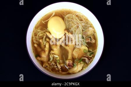 Soto ceker or chicken feet soup on black background. Stock Photo