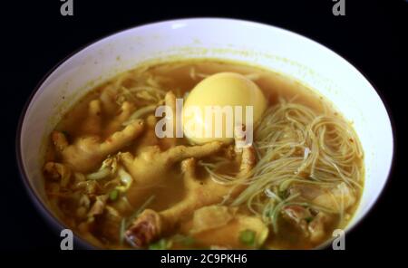 Soto ceker or chicken feet soup on black background. Stock Photo