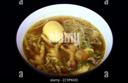 Soto ceker or chicken feet soup on black background. Stock Photo