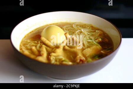 Soto ceker or chicken feet soup on black background. Stock Photo