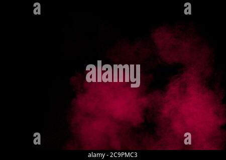 Abstract red powder dust explosion on black background. Stock Photo
