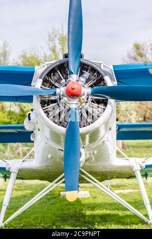 Old plane with propeller on beautiful bright sky background. Restored airplane Stock Photo