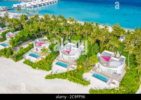 Perfect aerial landscape, luxury tropical resort or hotel with water villas and beautiful beach scenery. Amazing bird eyes view in Maldives, landscape Stock Photo